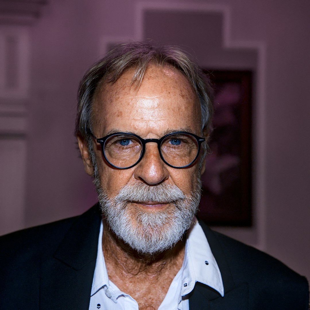 Studio portrait of a professional man with a beard wearing glasses