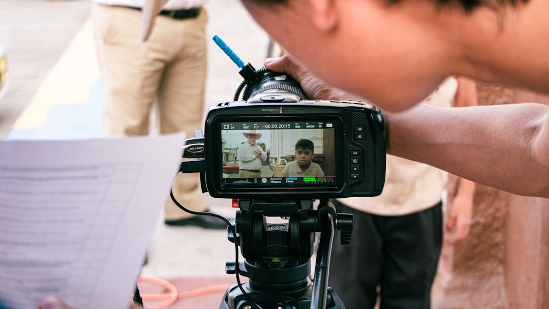 Television reporter filming a live news segment outdoors with a camera operator